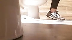 Woman on toilet in restaurant.
