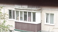 Neighbor girl is cleaning on the balcony